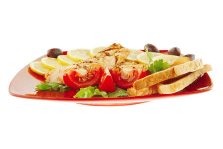 roast red salmon with lemon and tomatoesの写真素材