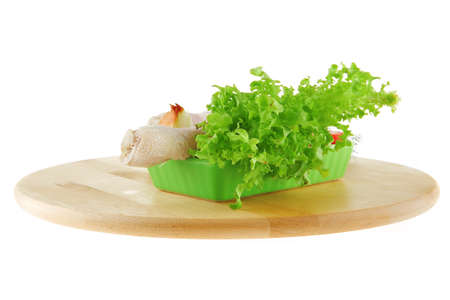 chicken legs on wooden plate over whiteの写真素材