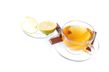 dark chocolate and tea with lemon on whiteの写真素材