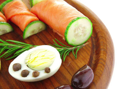 image of smoked salmon rolls on wooden plateの写真素材