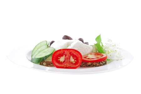 mozzarella on white plate with vegetables and breadの写真素材