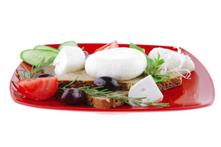 italian mozzarella and vegetables on red plateの写真素材