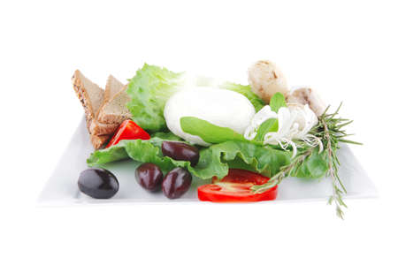 white cheese and bread with olives and tomatoesの写真素材