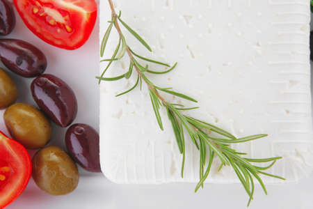 image feta cube and olive over white plate with breadの写真素材