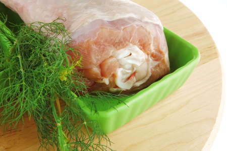 uncooked chicken legs on green over whiteの写真素材