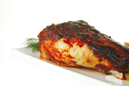 chicken legs on white with tomato and pepperの写真素材