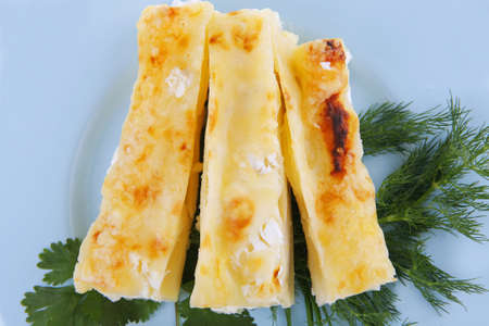 cheese cannelloni served with vegetables on blue plate