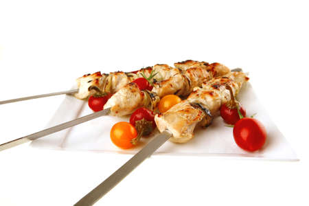fresh grilled chicken shish kebab on white platterの写真素材