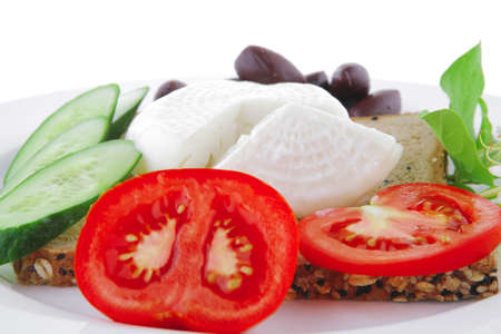mozzarella on white plate with vegetables and breadの写真素材