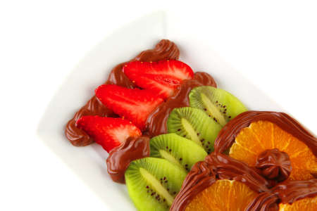 exotic fruits in cream on white plateの写真素材