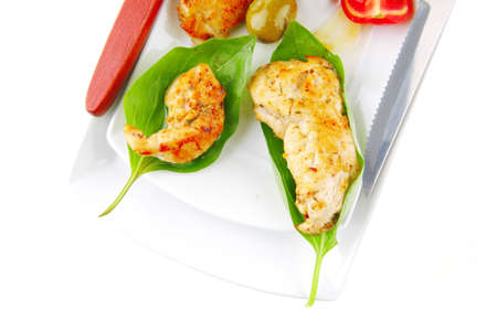 served roast chicken brisket on green leaf of basilの写真素材