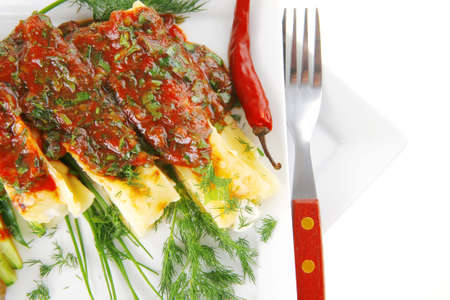 cheese cannelloni served with vegetables on square plateの写真素材