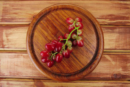 fresh raw red grape on wooden tableの写真素材