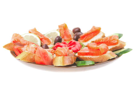 small salmon sandwiches served with vegetablesの写真素材