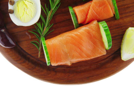 red smoked salmon slices with vegetables and lemonの写真素材