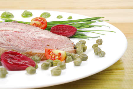 beef barbecue served on big white dish over woodの写真素材