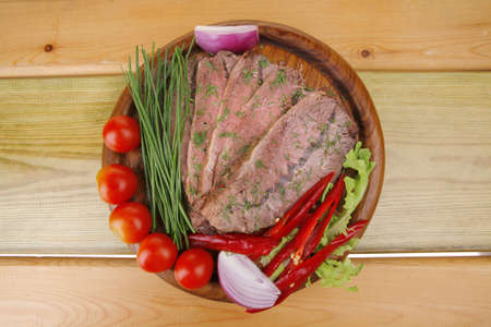 fresh grilled beef slice on wooden plateの写真素材