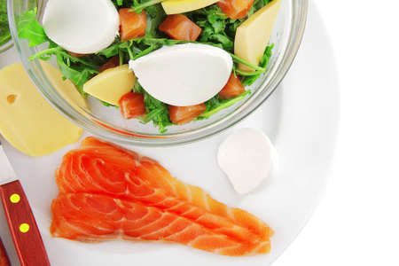 green salad with salmon and tomatoes in transparent bowlの写真素材