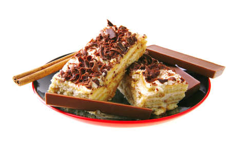 dark chocolate bars and light cake on small saucer
