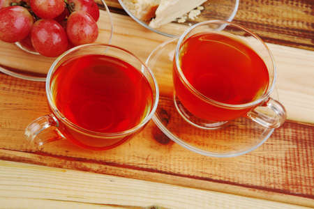 cake dessert and tea and grapes on woodの写真素材