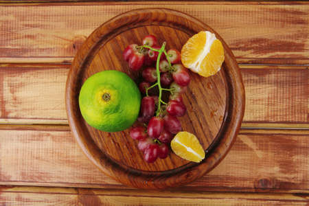 fresh raw red grape on wooden tableの写真素材