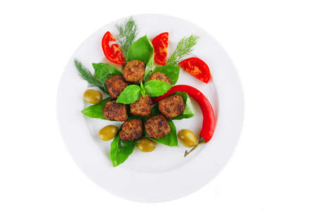 beef meatballs on basil with tomatoes and hot pepperの写真素材