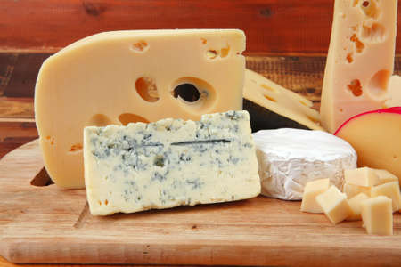 different cheeses served on wooding cutting board