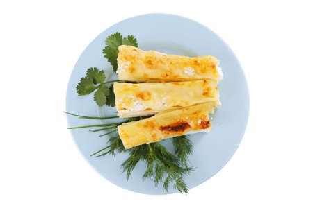 cheese cannelloni served with vegetables on blue plateの写真素材