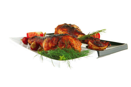 fresh roasted drumstick on ceramic plates with tomatoesの写真素材