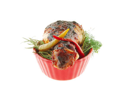 chicken leg over red bowl on whiteの写真素材