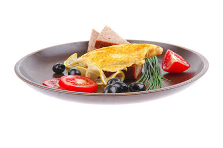 grilled fish fillet served with tomatoes,olives and breadの写真素材