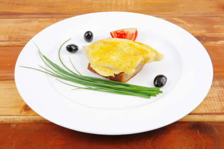 savory: fish fillet served on plate over wood with tomatoes,olives and bread の写真素材