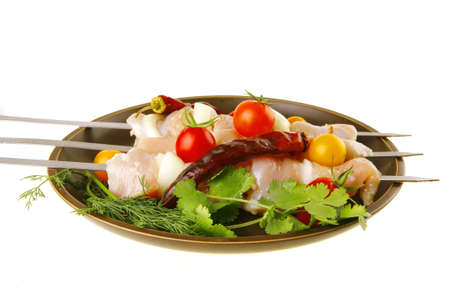 fresh raw chicken kebabs served with vegetablesの写真素材