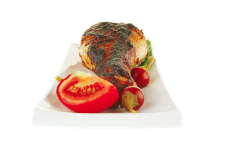 roasted chicken legs with greenery on white backgroundの写真素材