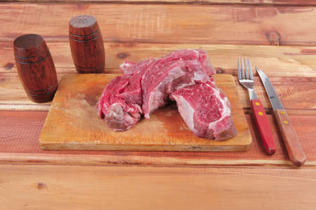 savory: fresh uncooked beef fillet mignon on board prepared for cooking on woodの写真素材
