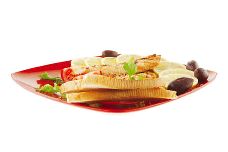 grilled salmon steak on red plate with tomatoesの写真素材