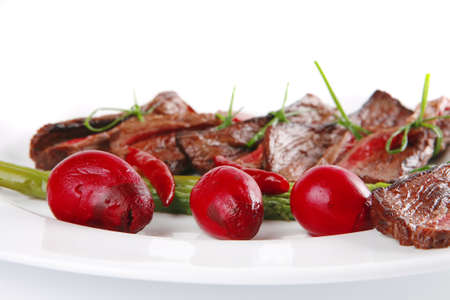 beef meat and red spices on white plateの写真素材
