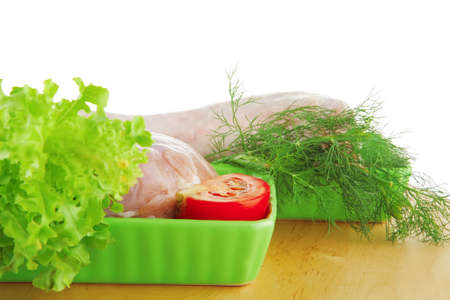 chicken legs on wooden plate over whiteの写真素材