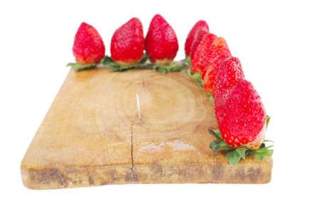 fresh ripe pink strawberry over wooden plateの写真素材