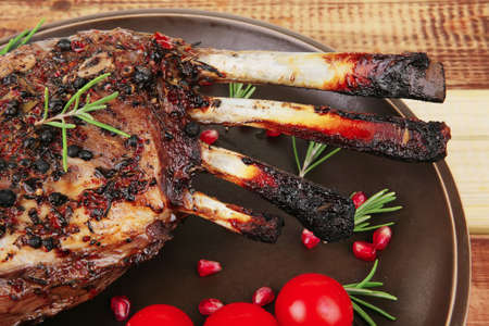 served charbroiled ribs on plate over woodの写真素材