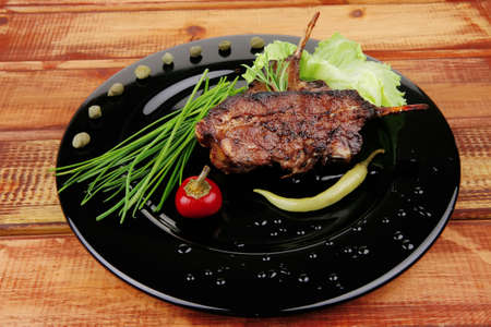 main course: barbecued ribs served with capers and chivesの写真素材