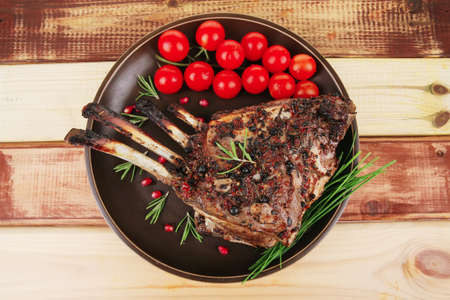 image of grilled ribs served on wooden tableの写真素材