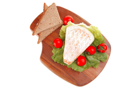 french cheese and tomatoes on wooden plateの写真素材