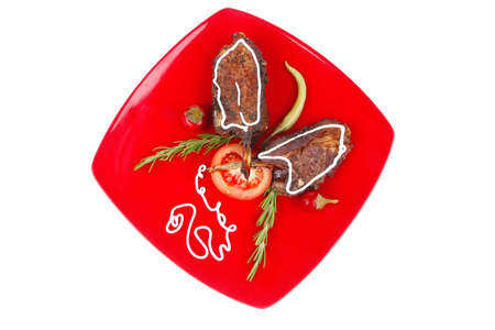 served entree: ribs on red plate with hot peppers and tomatoesの写真素材