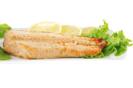 big grilled salmon steak over white plate