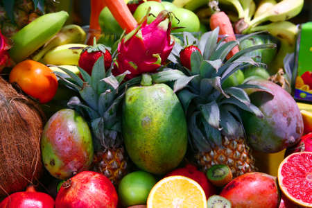 fresh raw lot of fruits on counter , illuminated by the sun