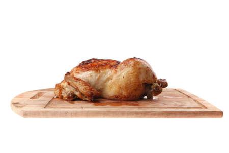 poultry : homemade roast whole turkey on wooden cutting board isolated over white backgroundの写真素材