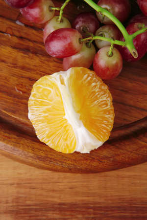 fresh raw red grape on wooden tableの写真素材