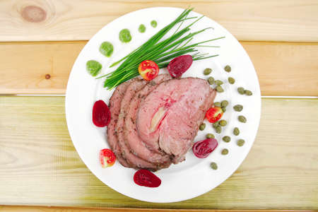 hot ham served on white dish over woodの写真素材