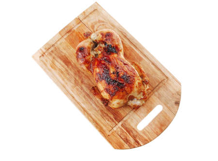 poultry : homemade roast whole turkey on wooden cutting board isolated over white background